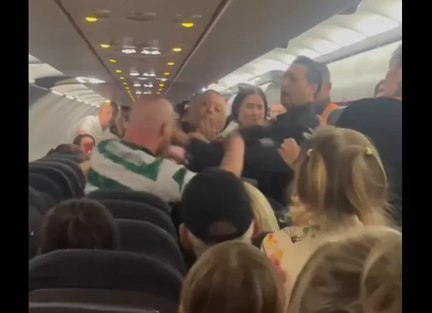 A Celtic fan assaulted police on a flight after drinking a bottle of vodka.