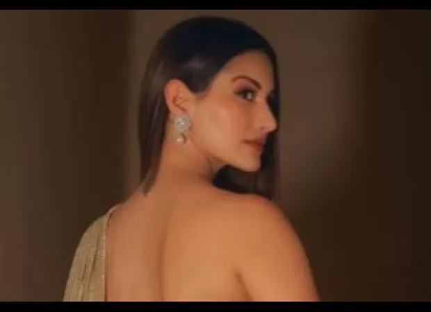 Amyra Dastur looks stunning in a gold saree.