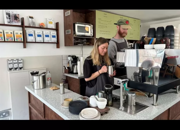 A cafe has prohibited the use of laptops after employees were told to lower their voices during Zoom meetings.