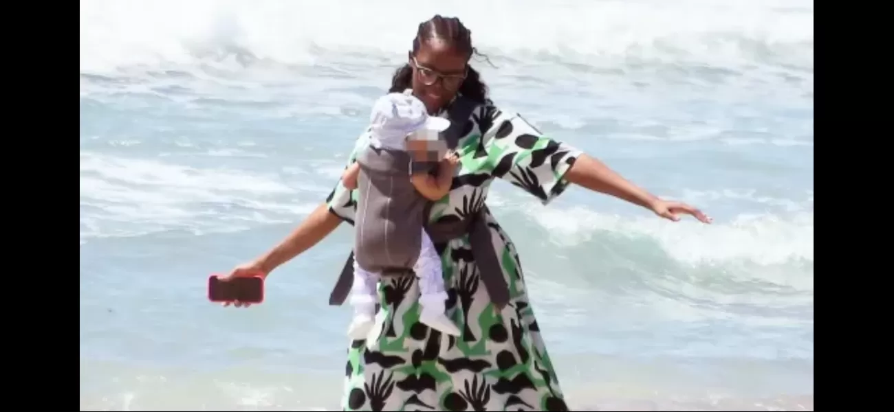 Dance competition celebrity enamored with 7-month-old daughter, twirls and sways with her on the shore.