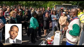 A large crowd attends vigil for boy who died in Hainault sword attack.