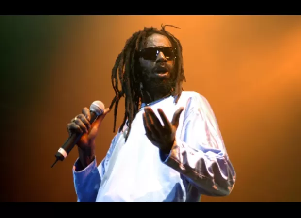 Reggae singer Buju Banton returns to the U.S. with reinstated visa, praising God's goodness.