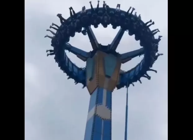Riders stranded upside down for two minutes as swing ride halts abruptly in mid-air.