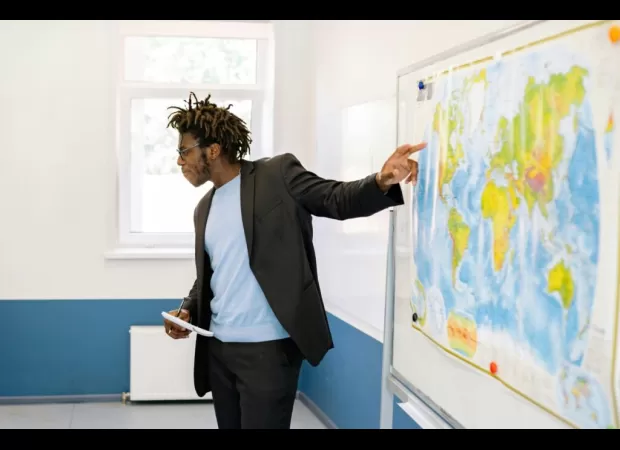 Controversy over male teacher allowing female students to braid his hair.