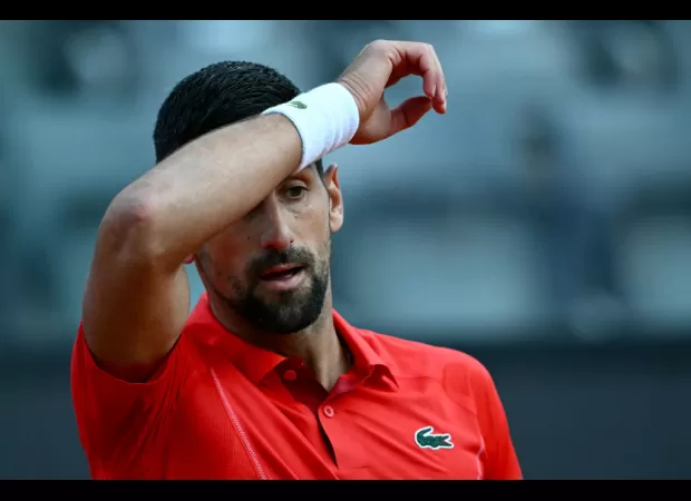 Tennis star Djokovic knocked down by water bottle while signing autographs during Italian Open.