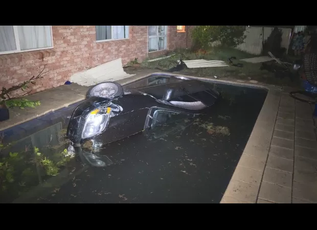 A driver crashes car into pool, escapes while soggy.