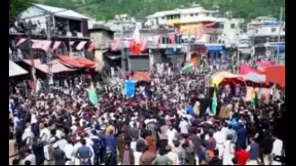 A police officer died and more than 100 people were hurt in a protest in PoK.