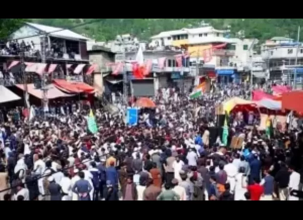 A police officer died and more than 100 people were hurt in a protest in PoK.