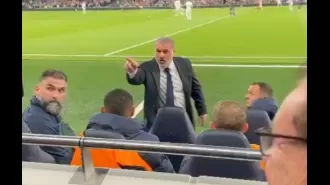 Soccer coach Ange Postecoglou confronts displeased fan during team's loss to Manchester City.