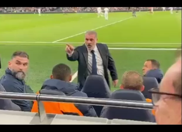 Soccer coach Ange Postecoglou confronts displeased fan during team's loss to Manchester City.