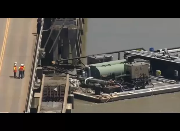 A barge accident results in an oil spill after crashing into a bridge on an island.