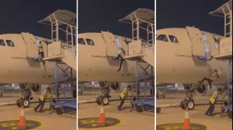 Indonesian airline employee drops from aircraft when stairs are removed.