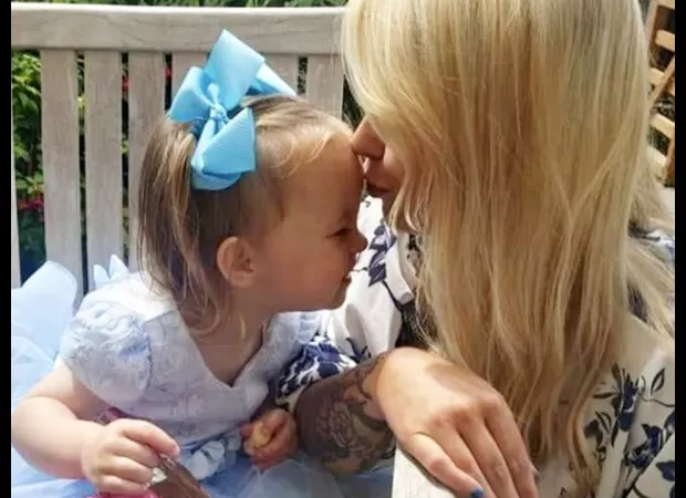 A young child clings to their mother's body after medical professionals overlooked a deadly heart attack.