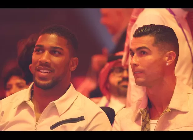 British boxer Anthony Joshua and Portuguese footballer Cristiano Ronaldo watch Tyson Fury vs Oleksandr Usyk match together at ringside.