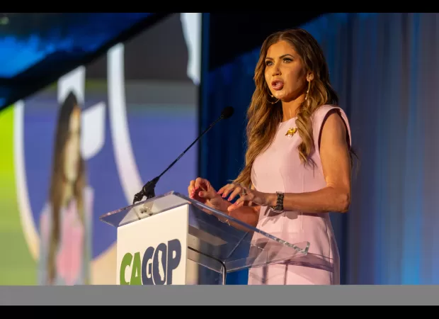 Republican politician Kristi Noem criticizes Gavin Newsom and Joe Biden at a California conference.