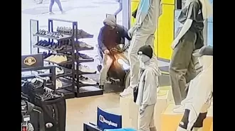 A man on a moped drove through a JD Sport store and then proceeded to kick a police officer in the face.