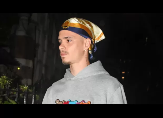 David Beckham's son Romeo, 21, looks just like his famous father as he wears his iconic bandana.