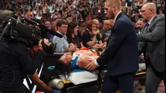 A WWE wrestler was taken out of the arena on a stretcher and placed in an ambulance after a intense match.