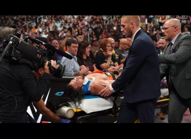 A WWE wrestler was taken out of the arena on a stretcher and placed in an ambulance after a intense match.