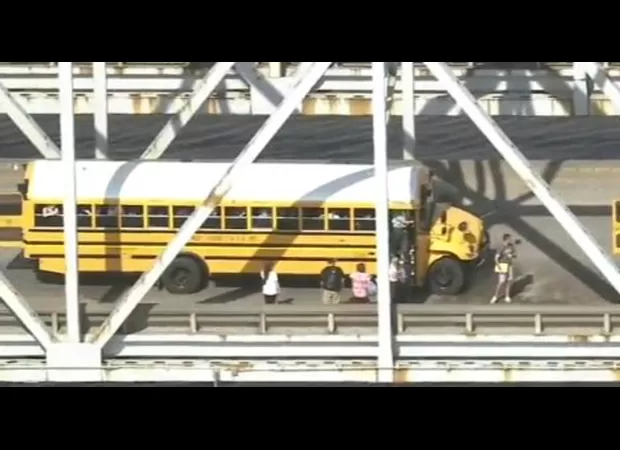 Three school buses crash into each other on a bridge.