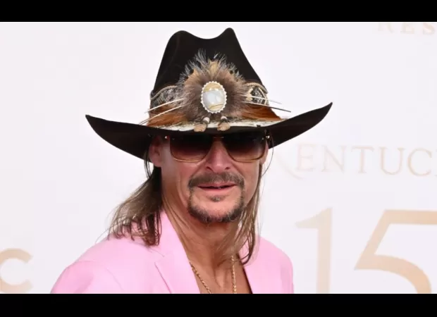 Kid Rock is accused of making racist comments and brandishing a gun while being interviewed, and admits to contributing to the division in America.