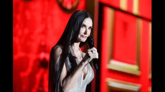Demi Moore angrily chides crowd while presenting Cher at Cannes.