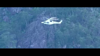 Man falls down mountainside in Queensland, rescue in progress.