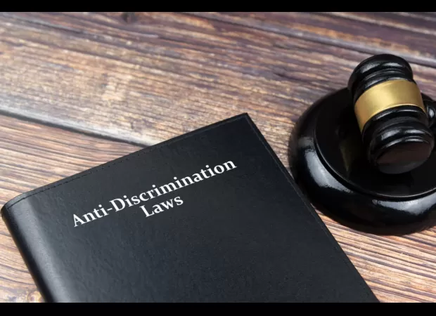 A high school student is taking legal action against the police for racial discrimination after being cleared of a theft charge.