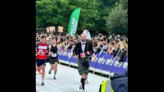 Scottish athlete breaks world record for completing marathon while wearing traditional Highland attire.