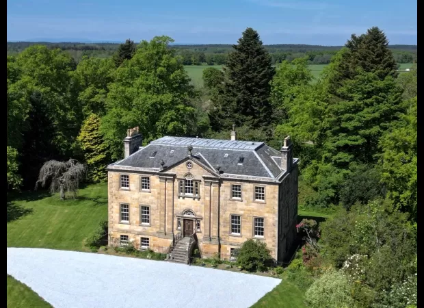 A large Georgian estate including a tennis court and orchard is up for sale for under £1 million.
