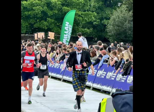 Scottish athlete breaks world record for completing marathon while wearing traditional Highland attire.