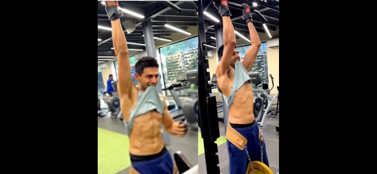 Kartik Aaryan shows off toned abs while doing weight-lifted pull-ups.