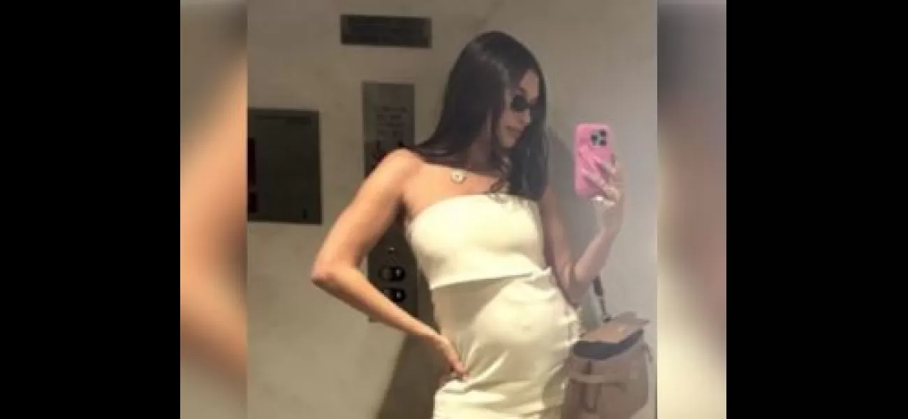 Hailey Bieber shows off her pregnant belly in a selfie taken in front of a mirror.