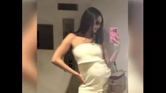Hailey Bieber shows off her pregnant belly in a selfie taken in front of a mirror.