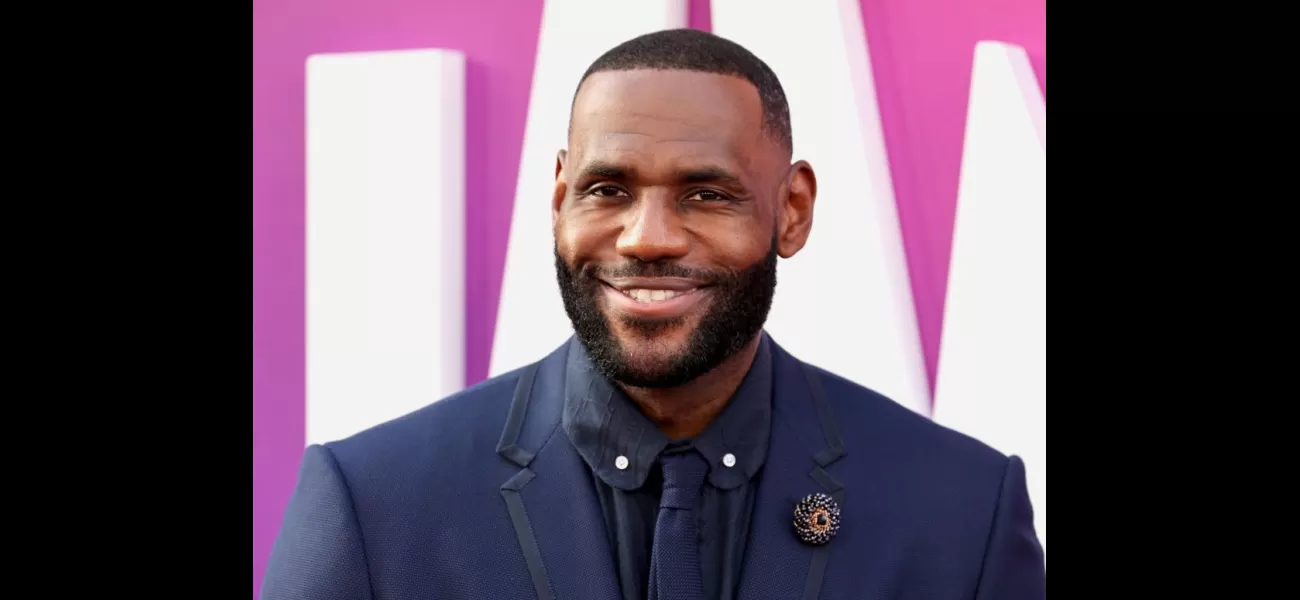 LeBron James celebrates the first graduate from his I Promise School.
