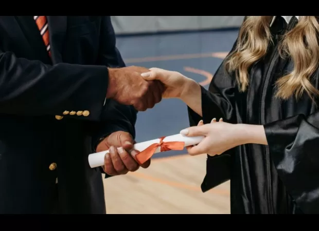 A father interrupts his daughter's graduation handshake with a black superintendent, sparking controversy about race and whiteness.