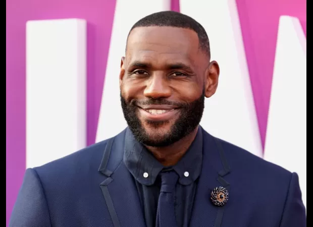 LeBron James celebrates the first graduate from his I Promise School.