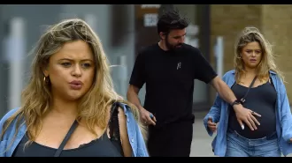 Expecting mom Emily Atack gets assistance from partner on walk before baby's birth.