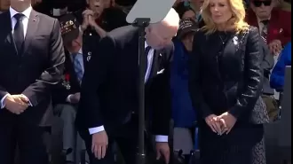 Biden criticized for unusual sitting posture during D-Day event.