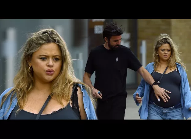 Expecting mom Emily Atack gets assistance from partner on walk before baby's birth.