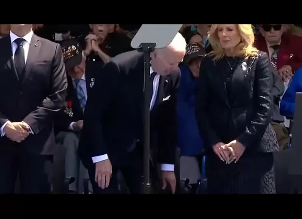 Biden criticized for unusual sitting posture during D-Day event.