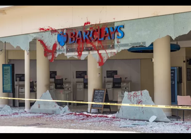 Protesters vandalize Barclays branches in UK with red paint.