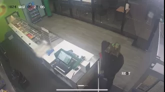 CCTV footage shows man using knife to rob fast food restaurant in Queensland.