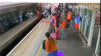 Baby in stroller hit by train on platform, causing fear.