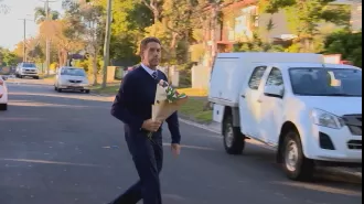 Deputy premier mourns mother and son killed in house fire in Queensland, pays respects with flowers.
