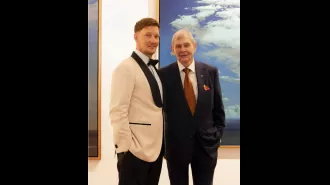 John Farnham, a famous musician, looking happy at his son's wedding.