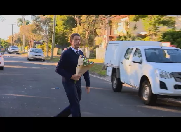 Deputy premier mourns mother and son killed in house fire in Queensland, pays respects with flowers.