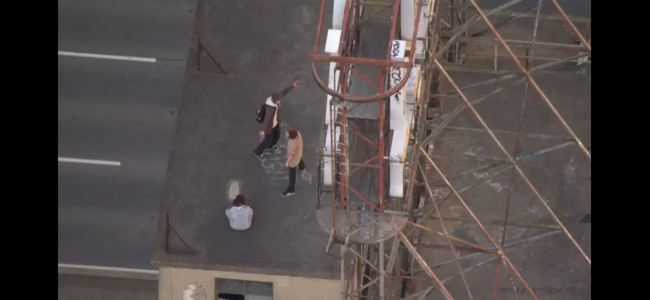 Helicopter sees teenagers climbing 14 floors in Melbourne.
