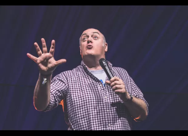 A comedian unexpectedly shows up at a wedding after performing at a nearby event.