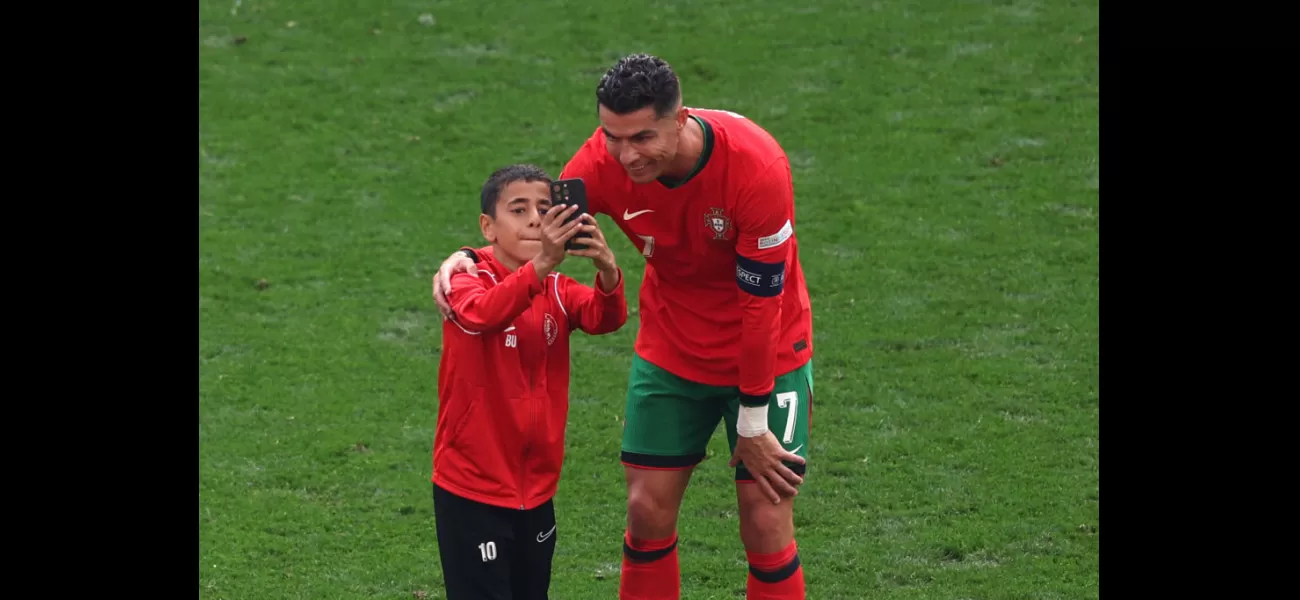Ronaldo takes selfie with pitch intruder during Portugal vs Turkey Euro 2024 match.